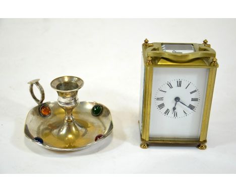 A French gilt brass carriage timepiece, 11cm high, together with a silver plated and cabochon set chamber stick, 7cm high (2)