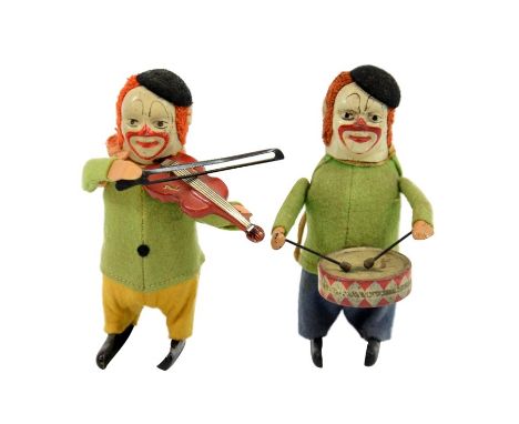 Two Schuco clockwork clown musicians, tin plate, modelled as band members playing the drums and a violin, stamped marks, one 