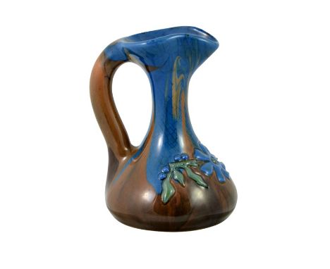 Edmund Harry Elton for Sunflower Pottery, an Elton Ware jug, pale blue and brown marbled glaze with relief moulded flower, pa