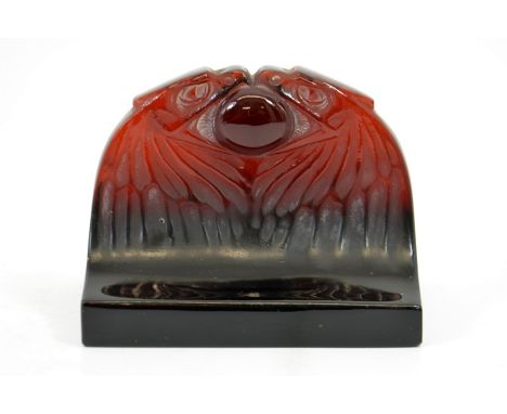 Rene Lalique, a deep amber glass Deux Aigles paperweight, model 801, designed circa 1914, highlighted with white staining, in
