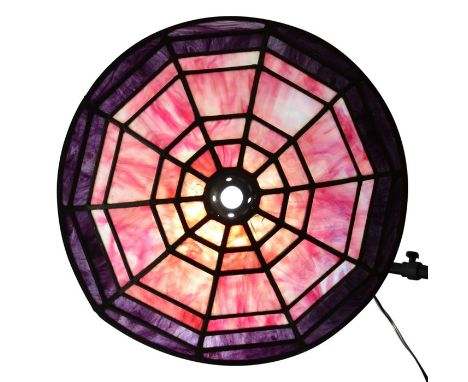 An American leaded and stained glass light shade, circa 1920, wide brimmed form, panels of magenta and mauve marbled glass, 5