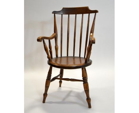 A 19th century circular elm seated stick back armchair, height 105cm.