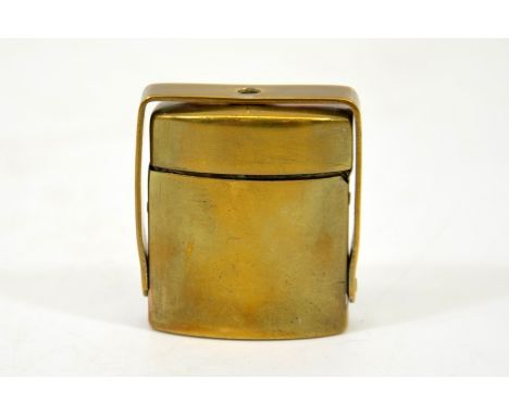 A travelling brass inkwell with safety bracket, contains glass bottle, 4.5cm high