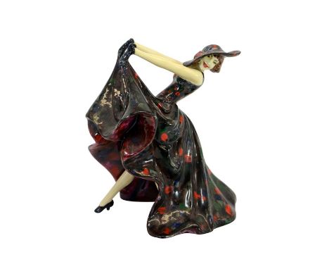 A Wade Art Deco cellulose figure of Jeanette, circa 1930s, modelled in mottled polka dot had and dress, signed, 17cm high