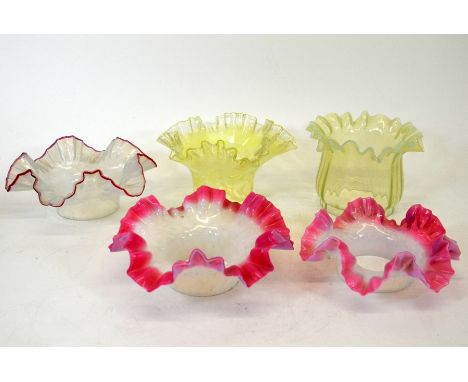 A collection of opalescent glass light shades, collar form, straw and pink and opaque, with crimped rims one by John Walsh Wa