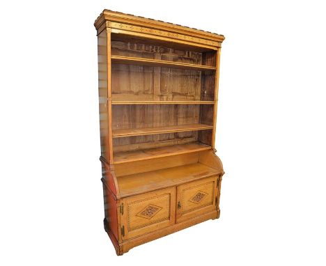 Charles Bevan (attributed), a large Gothic Revival oak bookcase cabinet, the five tier top with four pine shelves, incised wi