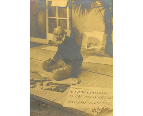 A signed portrait photograph of William Lionel Wyllie, painting outside a house, with sign ' Please contribute to the poor ar