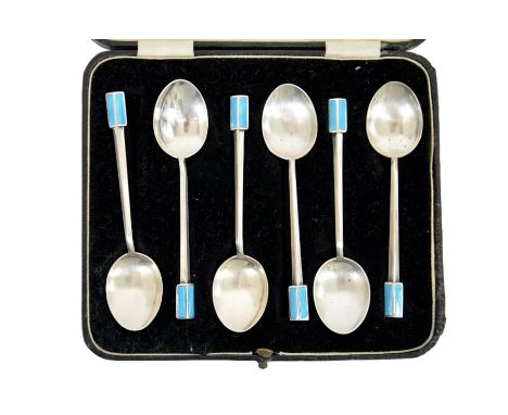 A cased set of Art Deco silver and enamelled teaspoons, triangular section with blue guilloche enamel terminals, possibly ret