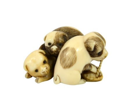 λ A 19th century Japanese ivory netsuke, Meiji, modelled as three puppies, 3.5cm