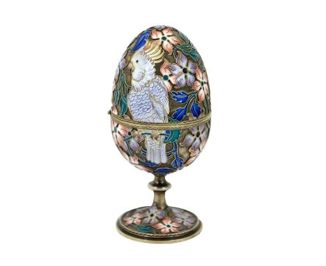 A Chinese silver gilt and champleve enamel egg, modelled with parrot, cockatoo and flowers, on pedestal stem, opening on a hi