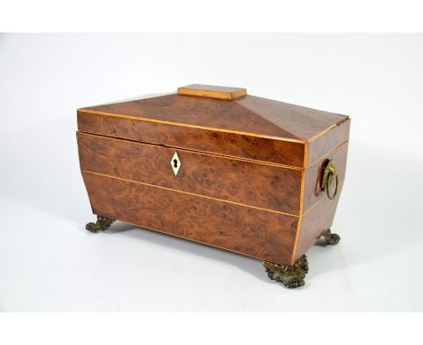 A George III yew wood tea caddy, circa 1820, sarcophagus form, satinwood strung, the interior with two lidded compartments, o