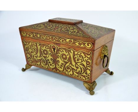 A George IV rosewood and brass inlaid tea caddy, circa 1830, sarcophagus form, the interior with two removable caddies, on fo