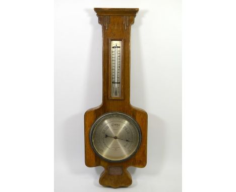 A Negretti &amp; Zambra barometer, circa 1950, in oak veneered case, silvered dial, 63.5cm long