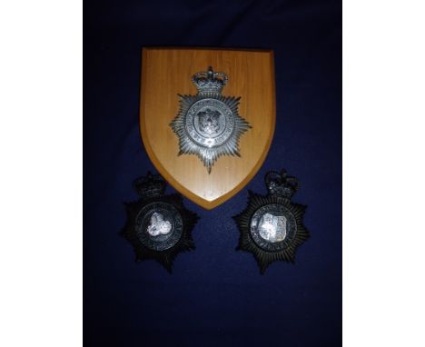 British Police white metal helmet badge for East Riding of Yorkshire Constabulary mounted on wooden wall plaque and two black