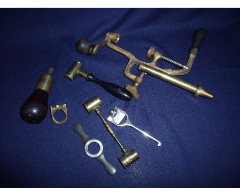 Box containing a selection of various brass and ebony handled powder measures, turnover tools, cartridge extractors etc  