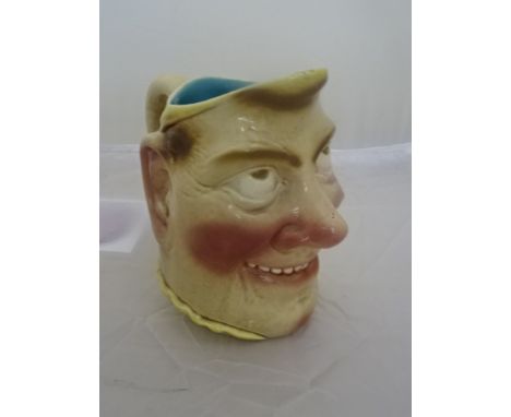 A Sarreguemines water pitcher with grotesque face
