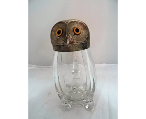An unusual Victorian novelty silver and glass claret jug, modelled as an owl, by E Hutton, London 1893.   The hinged cover se