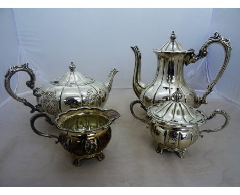 A modern silver three piece tea service and matching coffee pot, by Frank Hawker, Birmingham, 1975, all of melon form and ras