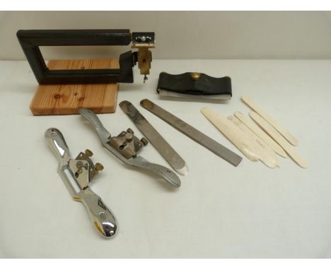 Book Binding Equipment.&nbsp; Small collection of book binder's tools including a paring machine, two spokeshaves, two liftin