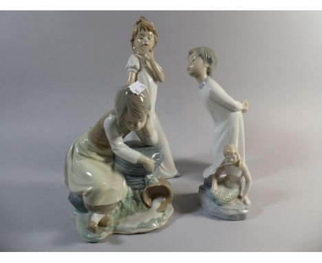 A Collection of Three Nao Figures of Children and Mermaid Ornament 