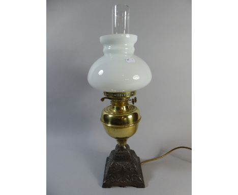 A Victorian Brass and Iron Oil Lamp Converted to Electricity with Opaque Shade, 54cm High