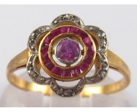 A yellow metal (tests 18 carat gold) pink sapphire, ruby and diamond ring, size P, 2.8 gms.
