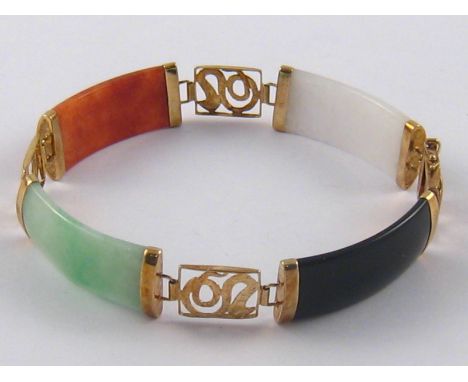A yellow metal (tests 14 carat gold) jade bracelet, 19cm long, 12mm wide, 16.9 gms.