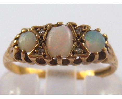 A 9 carat gold opal and diamond ring, size M ½, 1.6 gms.