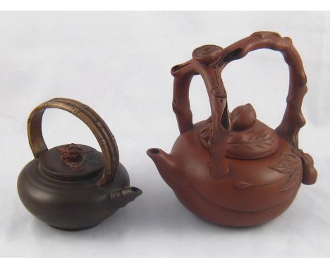Two Chinese ceramic Yixing style teapots , one with lotus fruit and naturalistic handle, ht. 16.5cm., one with naturalistic b