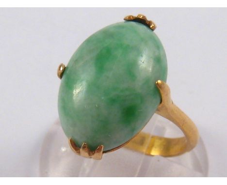 A yellow metal (tests 18 carat gold) jade ring, accompanied by Hong Kong Jade & Stone Laboratory report number SJ 112180 stat