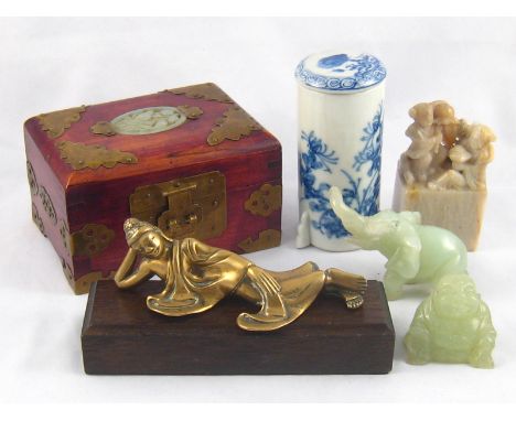Two carved green hardstone figures, being  a seated Buddha, 4.5cm., and an elephant, 6cm.; a Chinese soapstone group, ht.9cm.