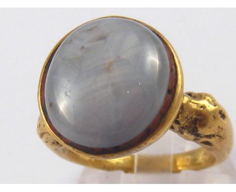 A gilt metal star sapphire ring, possibly ancient, sapphire approx 16 x 14mm, ring size R, 16 gms.