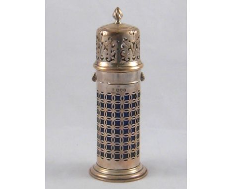 A silver lighthouse caster with bayonet fitting scroll pierced top and flame finial, the geometrically pierced body with blue