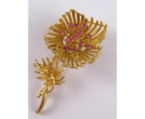 A yellow metal (tests 18 carat gold, pin untested) floral brooch, the petals mounted on hinges, opening to release the loose 