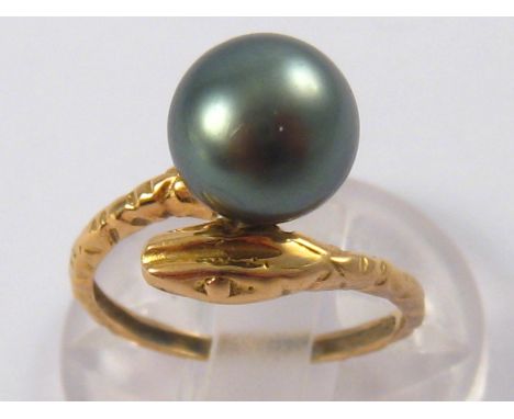 A vintage 18 carat gold serpent ring, set with a grey cultured pearl, pearl approx 8.7mm diameter, ring size J, 2.5 gms.

