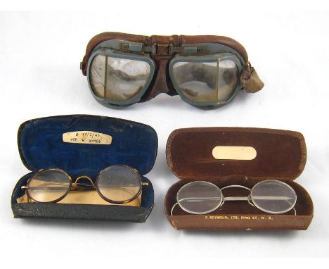 A mixed lot comprising two pairs of vintage spectacles and a pair of vintage flying goggles.
