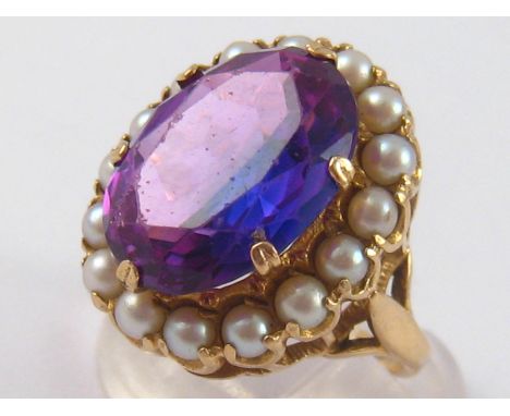 A 9 carat gold synthetic amethyst ring, size K, 7.1 gms.
