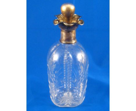 A four lipped silver mounted spirit decanter, the lobed body cut with flower designs.  German 800 assay. Ht. 22cm. 