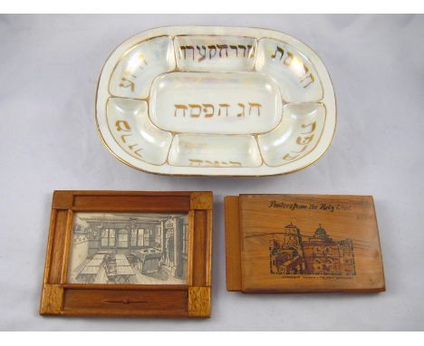 Judaica. A ceramic rounded rectangular Seder plate with gilt lettering 30x22cm., together with a book of pressed flowers in o