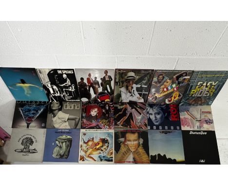 An assortment of vintage 12" vinyl including Rod Stewart, Culture Club, Eagles, Adam & the Ants, Cat Stevens, The Specials, M
