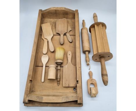 A collection of wooden kitchenalia including butter pats and pattern moulds