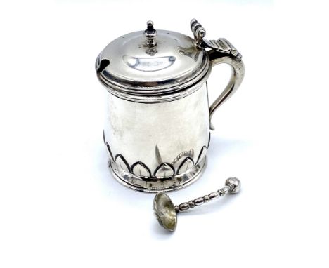 A Birmingham 1920 silver mustard pot with lotus flower detail to the base, complete with blue glass liner and replacement sil