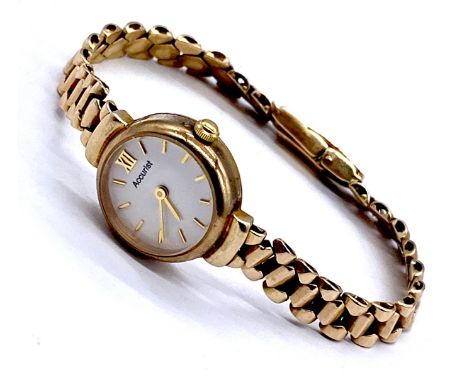A 9ct gold ladies Accurist wrist watch white face with baton numerals on 9ct gold strap,13.7g total weight.