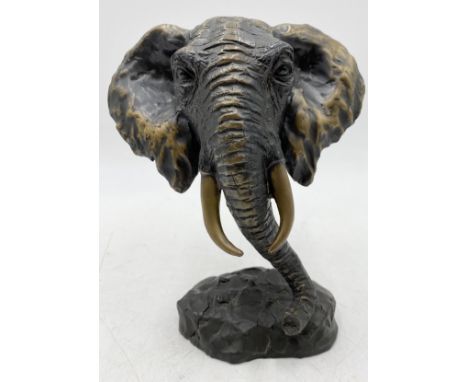 A lost wax bronze sculpture depicting the head of an elephant, raised on naturalistic base, signed Milo to the reverse, heigh