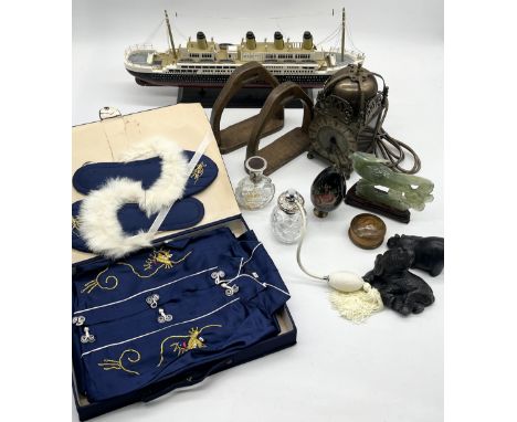 A collection of various items including Chinese slippers and robe, wooden model of the Titanic, wooden stirrups, Smiths clock
