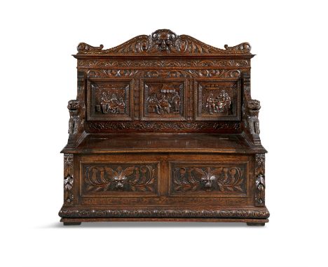 A VICTORIAN JACOBEAN REVIVAL CARVED OAK SETTLE, the three panel back with figural tavern scenes in low relief, within carved 
