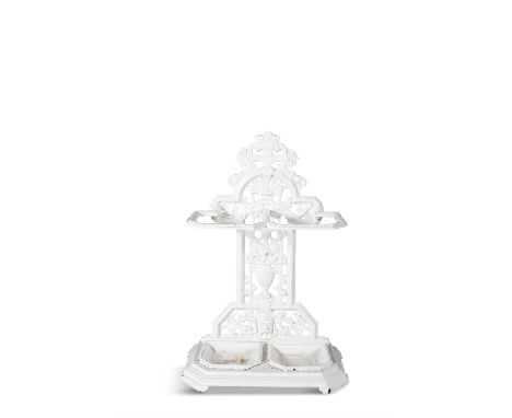 A VICTORIAN WHITE PAINTED CAST IRON STICK STAND, with pierced backplate and twin stick retainer, detachable drip pans on an o