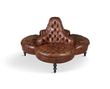 A CONTEMPORARY BUTTON BACK CONVERSATION SEAT, in four sections, upholstered in close nailed brown leather, raised on turned t
