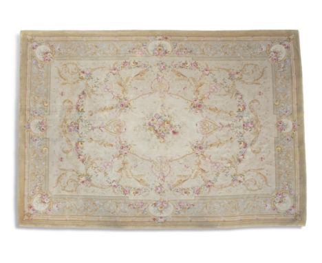 AN AUBUSSON PATTERN TAPESTRY CARPET, the cream ground decorated with a central floral medallion and with all-over foliate scr