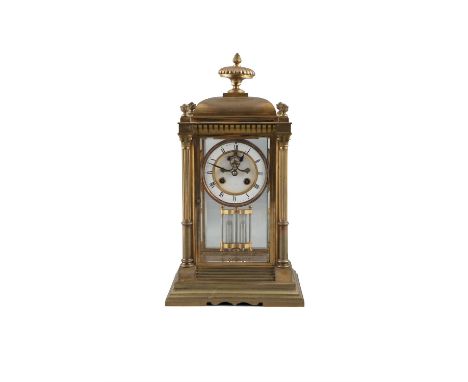 A BRASS FRAMED FOUR GLASS MANTLE CLOCK, with mercury pendulum and circular white enamel dial surmounted by urn finial and sup